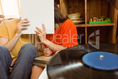 Young couple listening to vinyl record