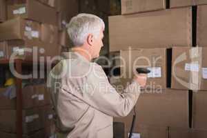 Worker scanning package in warehouse