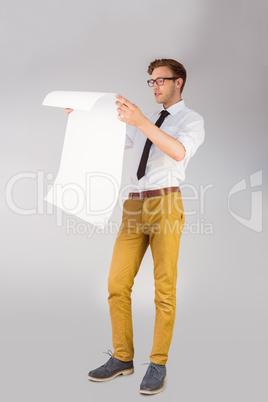 Geeky businessman reading large page