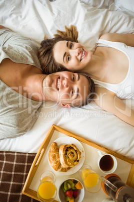 Cute couple having breakfast in bed