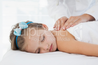 Small smiling girl lying on a table