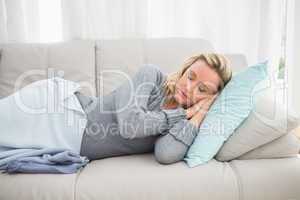 Casual pretty blonde lying on couch sleeping