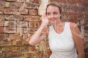 Smiling businesswoman against brick wall