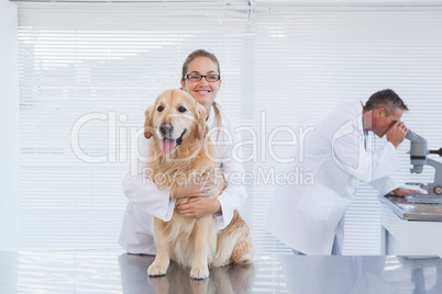 Smiling doctor holding a labrador