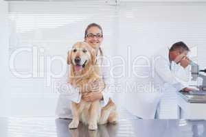 Smiling doctor holding a labrador