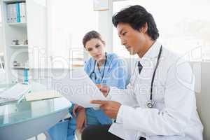 Doctor and surgeon reading notes