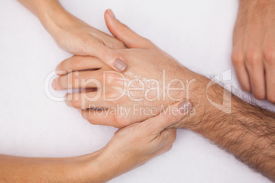 Manicurist washing customers hand