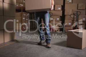 Worker with box in warehouse