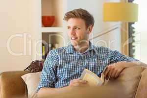 Young man reading on his couch