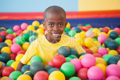 Cute boy smiling in ball pool