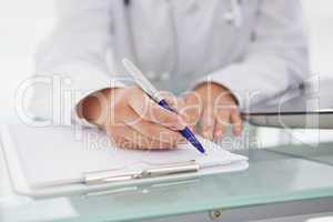 Doctor writing down medical notes
