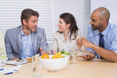 Workers chatting while enjoying healthy lunch