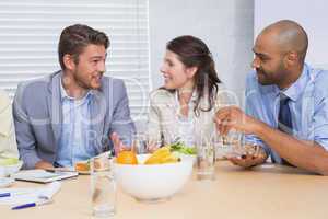 Workers chatting while enjoying healthy lunch