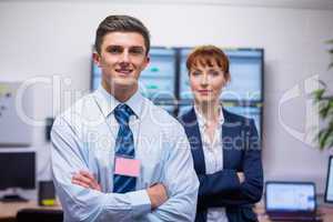 Smiling technicians standing at the camera with arms folded