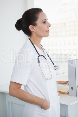 Doctor looking away with hands in pockets