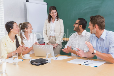 Casual business team clapping at presentation