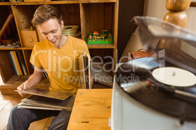 Young man looking at his vinyl collection