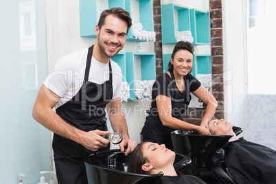 Hairdressers washing their clients hair