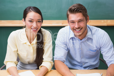 Casual business team smiling at camera during meeting