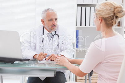 Patient consulting a serious doctor
