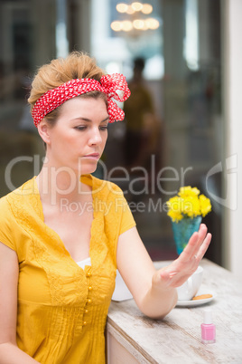 Pretty hipster looking at her wet nails