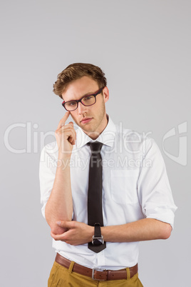 Young businessman thinking looking at camera