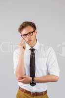 Young businessman thinking looking at camera