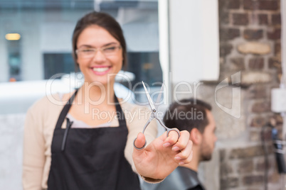 Pretty hair stylist smiling at camera