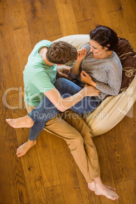 Cute couple laughing together on beanbag