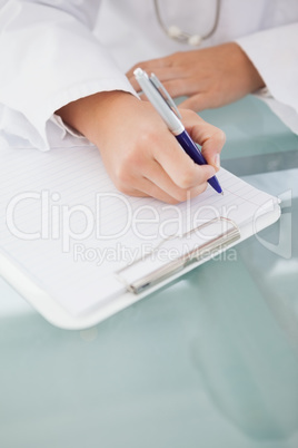 Doctor writing down work notes