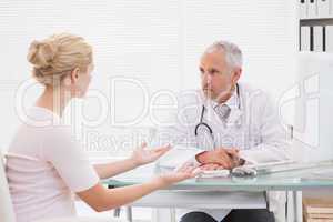 Patient consulting a serious doctor