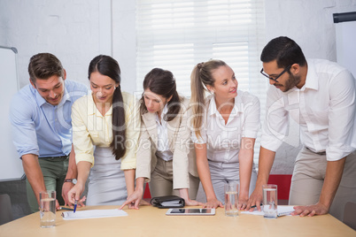 Smiling business people working together on a document