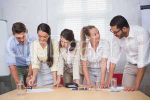 Smiling business people working together on a document