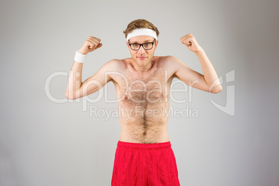 Geeky shirtless hipster flexing biceps