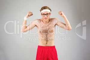 Geeky shirtless hipster flexing biceps