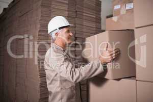 Warehouse worker loading up pallet