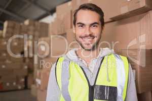 Smiling manual worker in warehouse