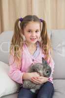 Cute little girl with her pet bunny