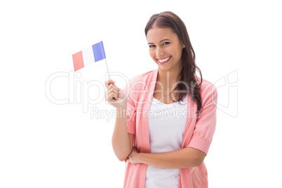 Pretty brunette smiling and holding french flag