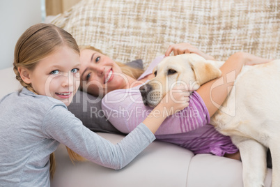 Mother and daughter with pet labrador