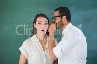 Man whispering secret into friends ear