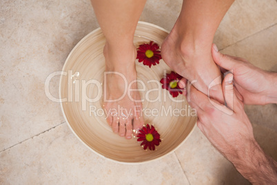 Pedicurist washing a customers feet