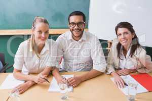 Casual business team smiling at camera during meeting