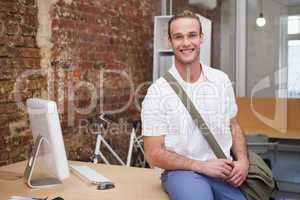 Man sitting on the table and smiling at camera