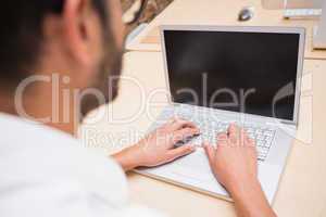 Cropped businessman using laptop at desk