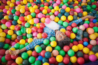 Cute boy smiling in ball pool