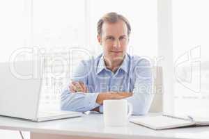 Relaxed businessman smiling at camera