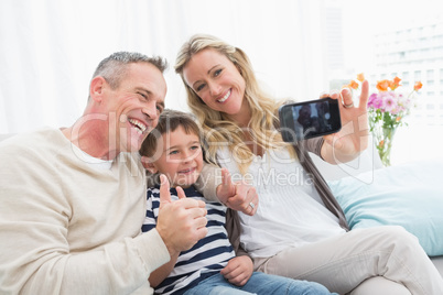 Cheerful family taking self pictures with a smartphone