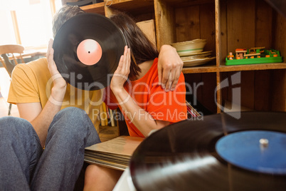 Young couple listening to vinyl record