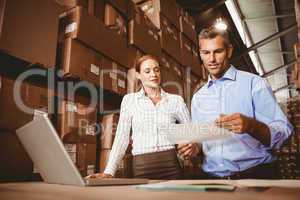 Colleague with laptop at warehouse